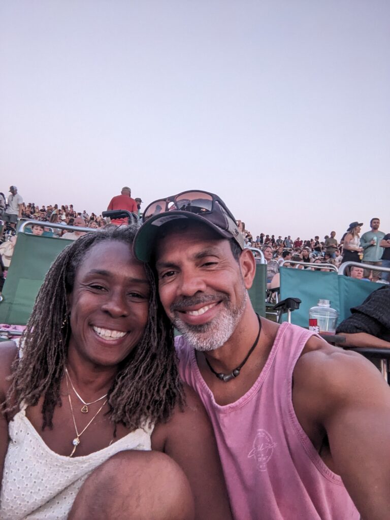Scott Saffold and his wife at a packed outdoor amphitheater.